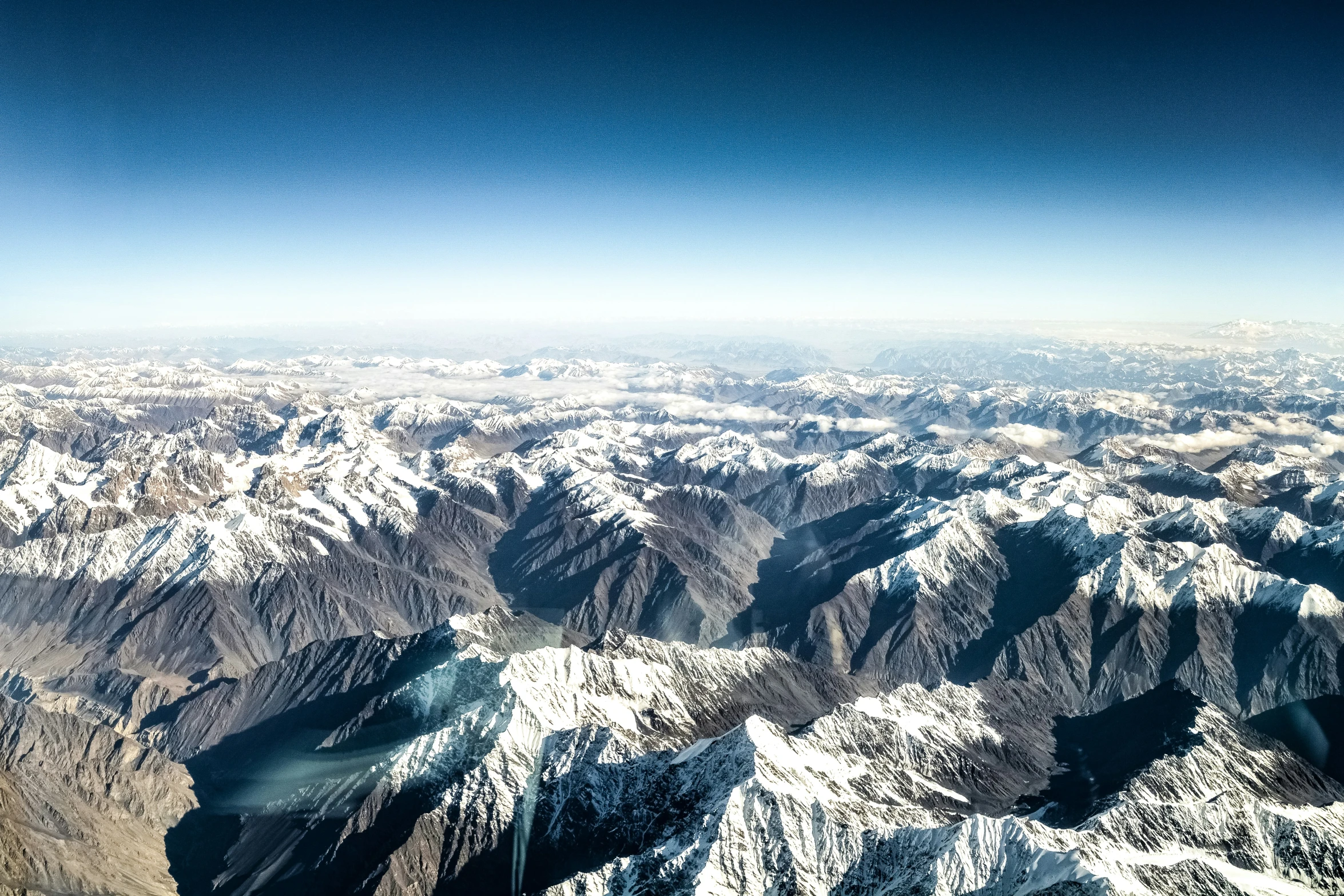 mountains from the air are covered in snow