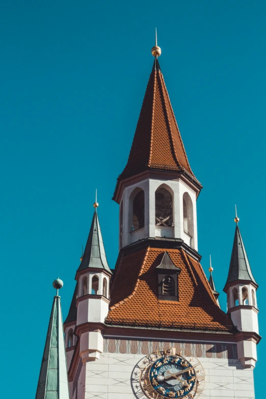 a clock tower with a weather vane and a bell