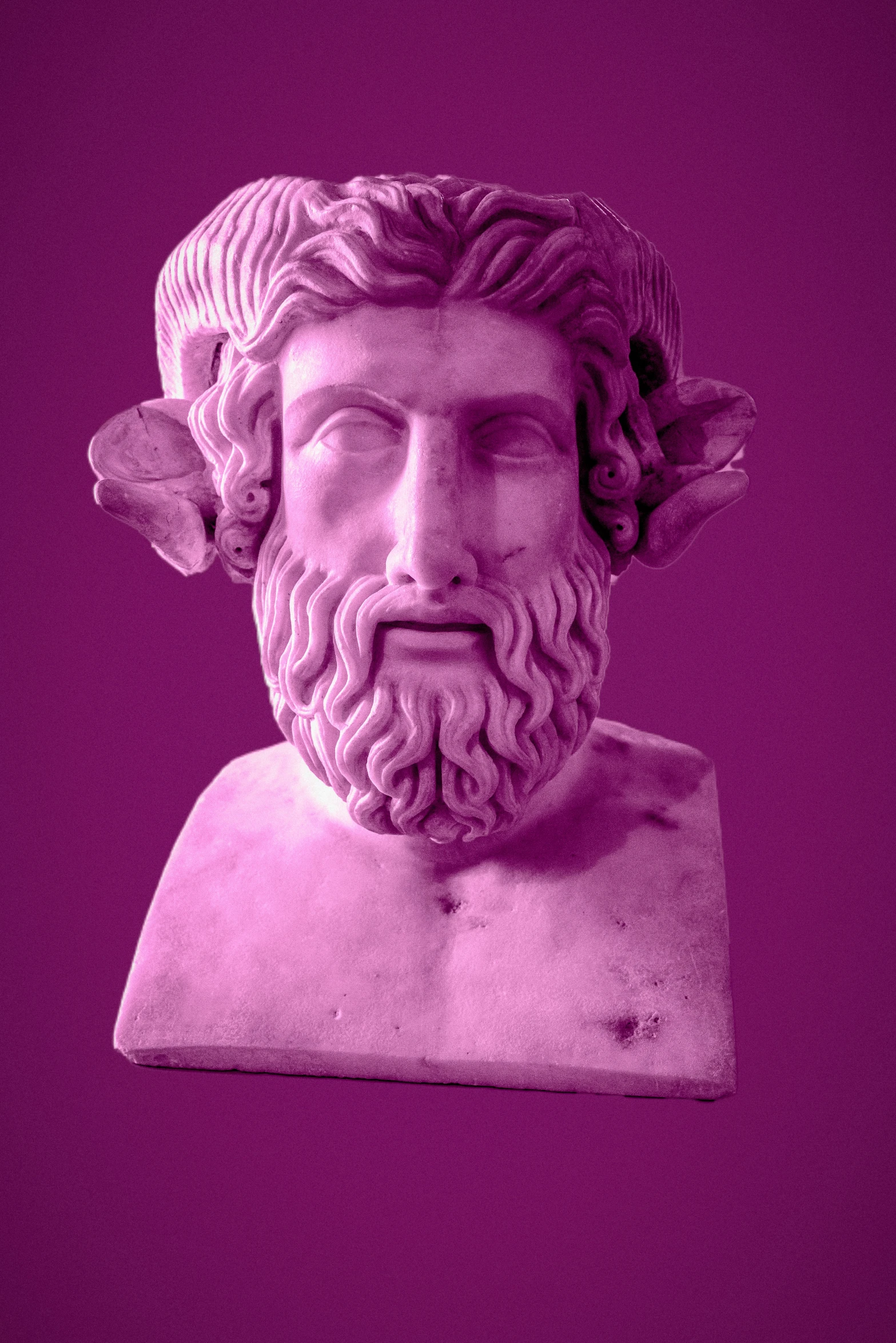 a statue of a bearded man with a purple background