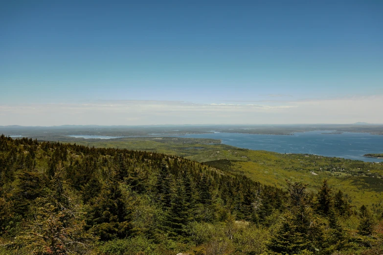 a view from the top of a hill near the water