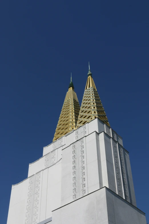 two tall, elaborate spires are against the blue sky