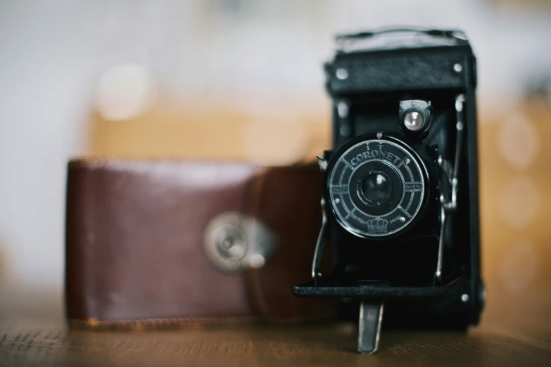 an old brown vintage film camera on a wooden table