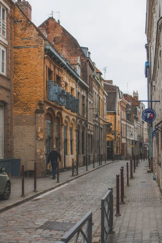 the view of a narrow street with lots of buildings