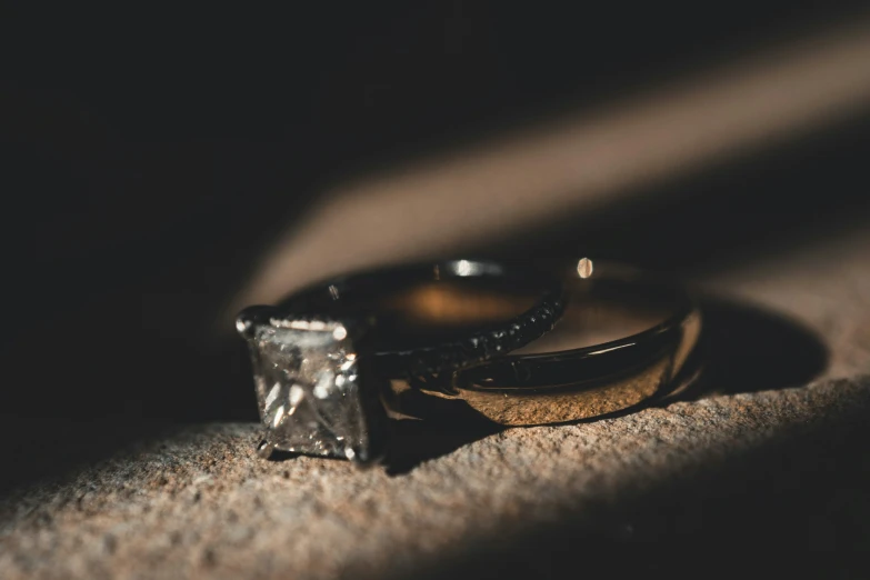 close up s of two wedding rings with a diamond ring