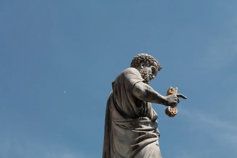 a statue that is standing on some dirt