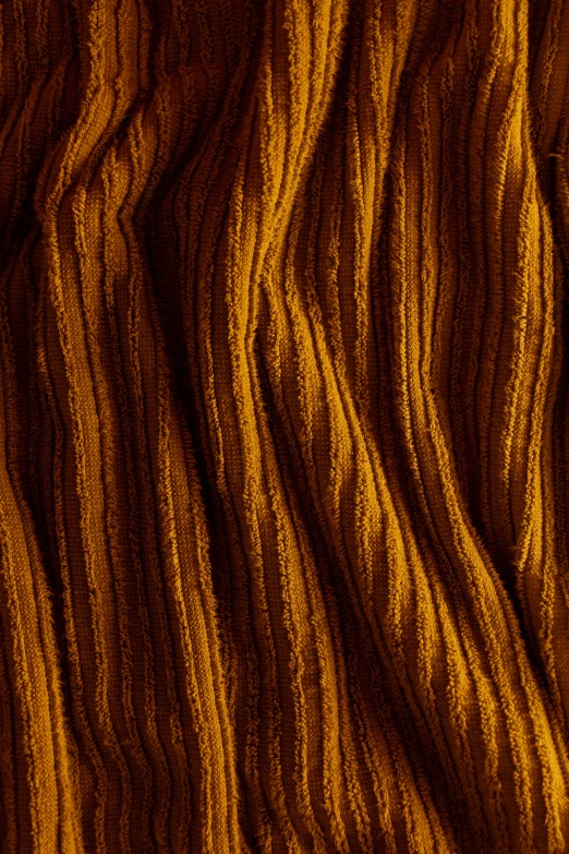 close up of a knitted sweater in orange and yellow