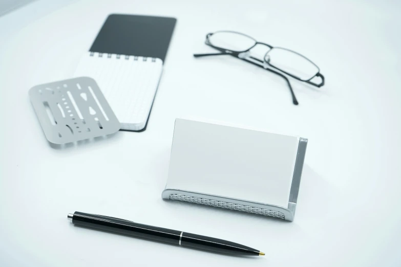 various items such as pen and notebook on white surface