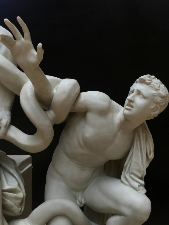 two white statues of men fighting each other