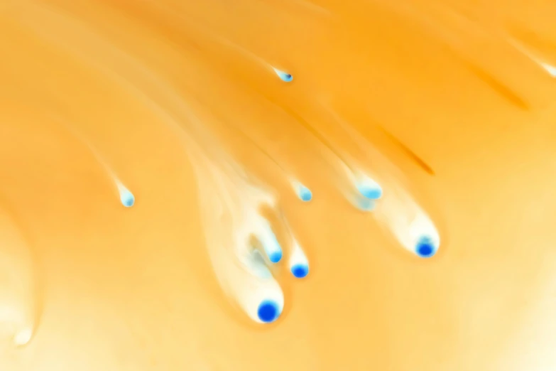 four drops of water that are on a yellow background