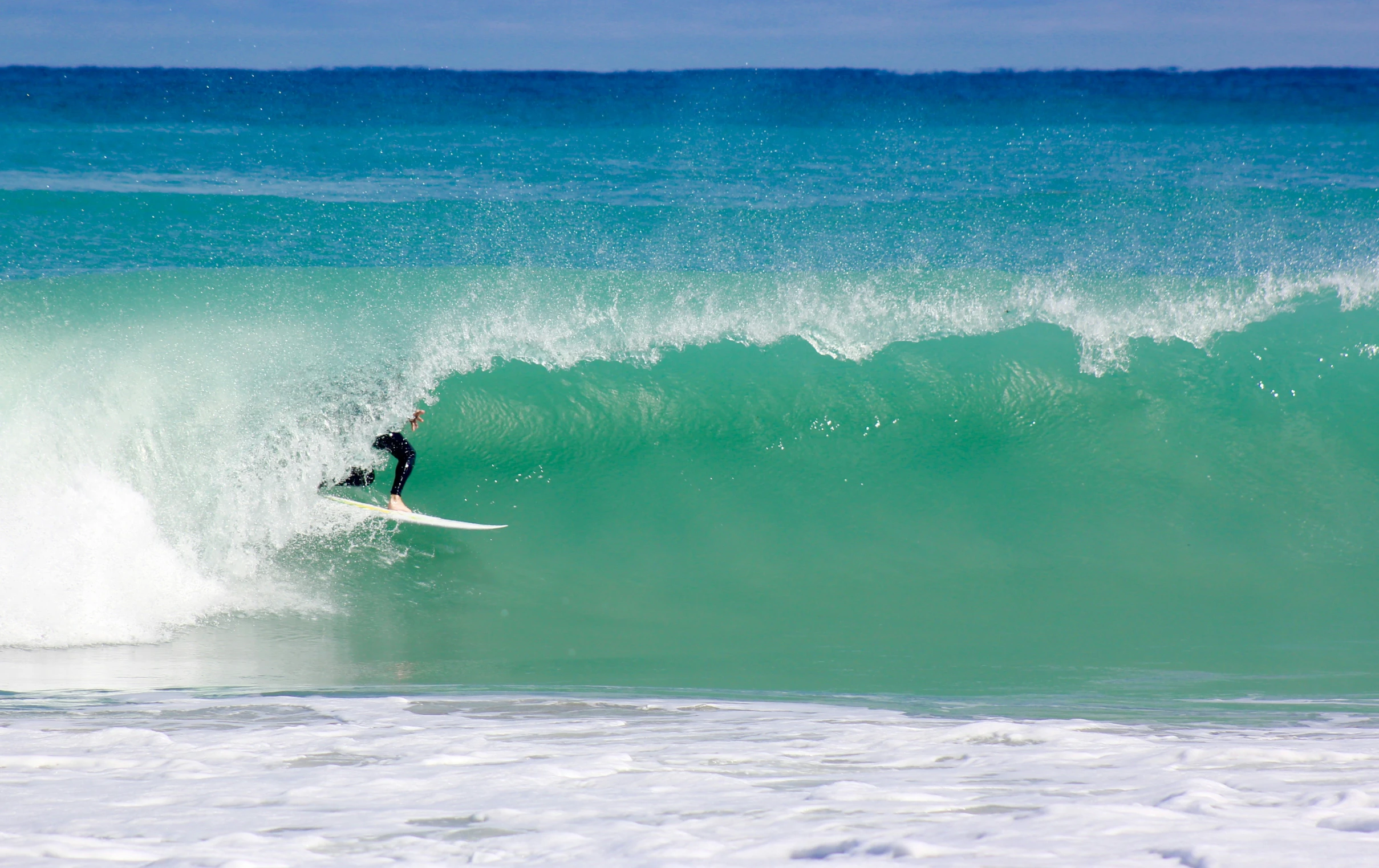 a person is riding the waves on a surfboard