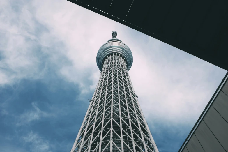 there is a tall structure under the cloudy sky