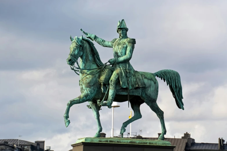 statue with large green feathers on head riding a horse