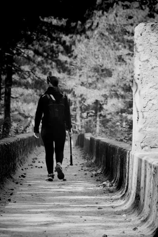 a person walking down a path near trees