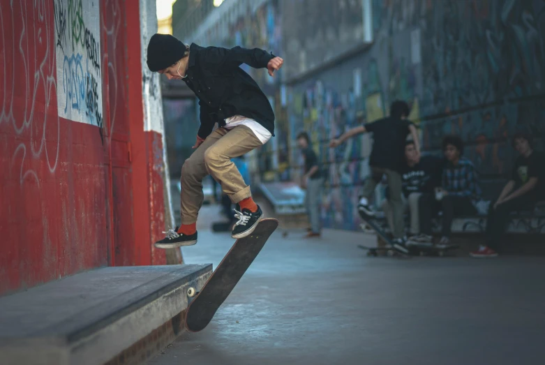 a young man is jumping with his skateboard over a ledge