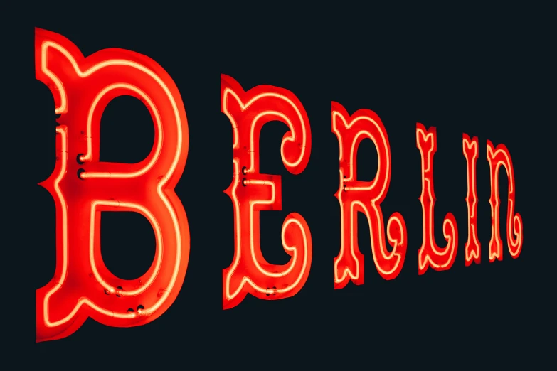 a neon bar sign lit up against a dark background