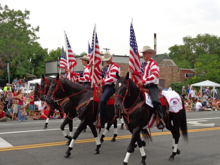 a couple of people on some horses in the street