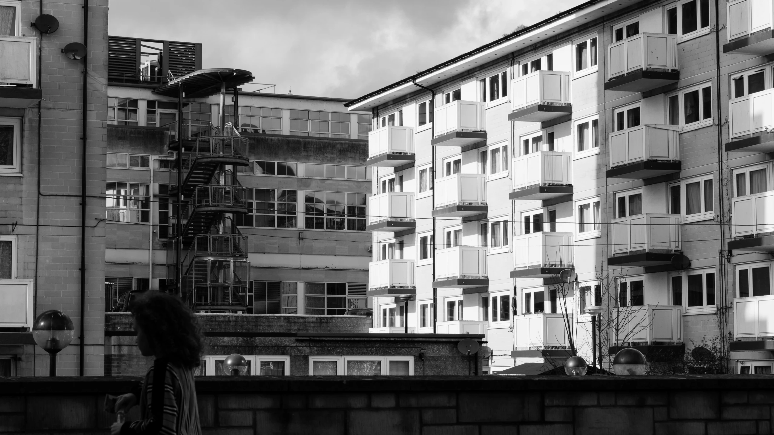 this woman is looking down at a bunch of buildings