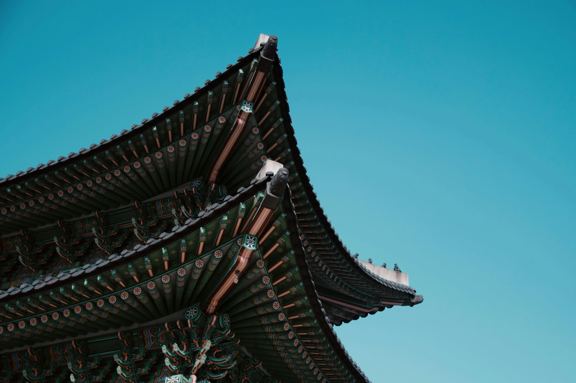 a tall asian building on top of a blue sky