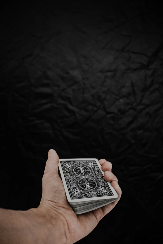 a person holds out an intricately designed playing card