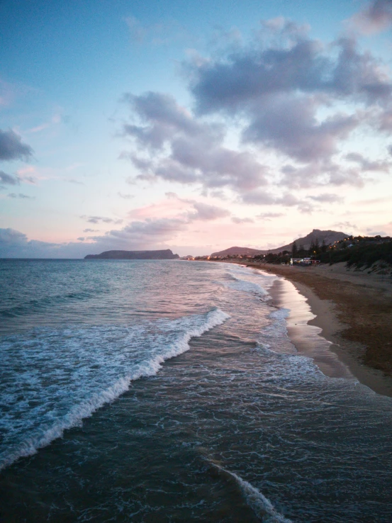 a beach with waves coming in at the shore