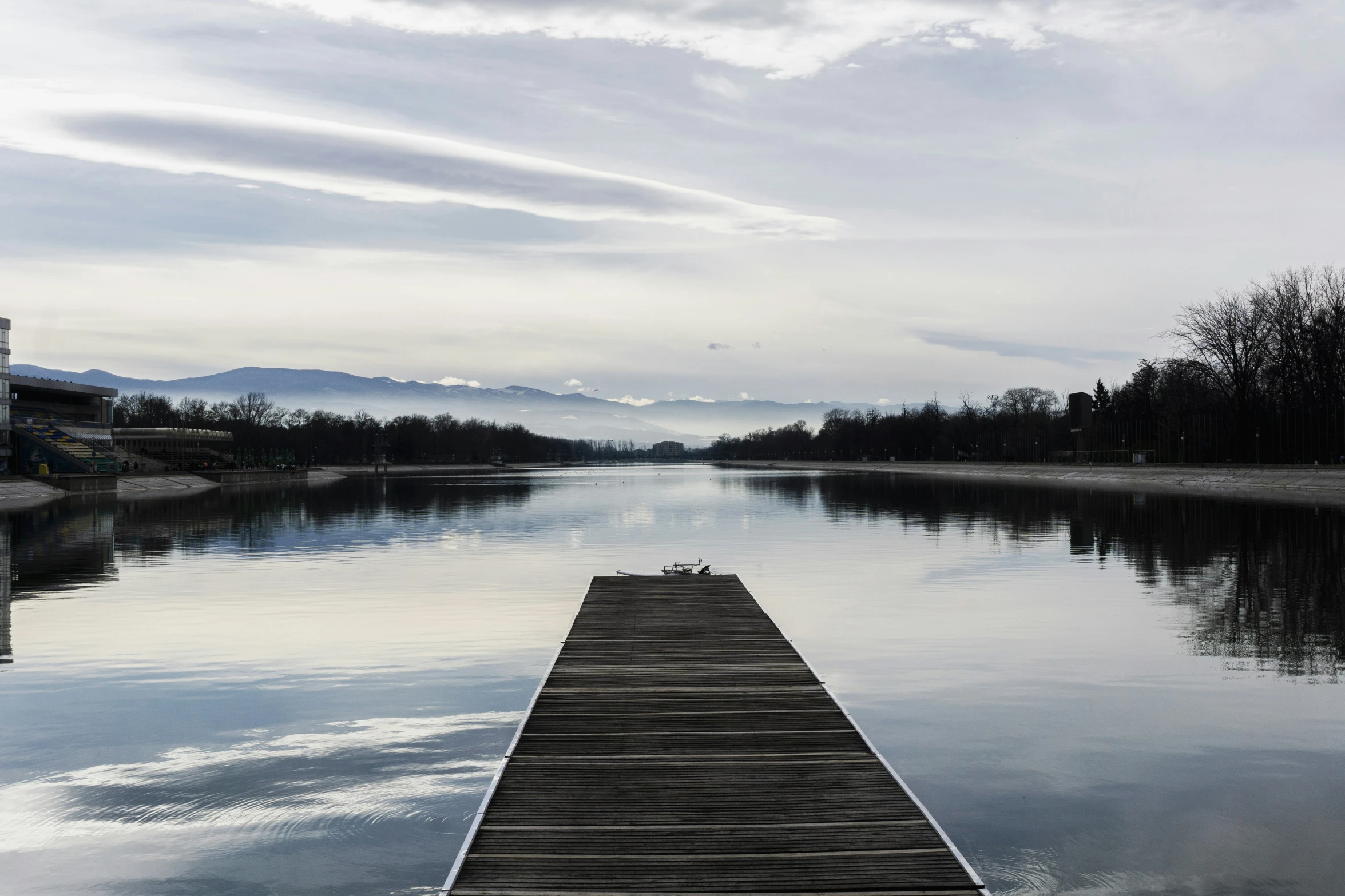 a wooden dock sitting in the middle of a river