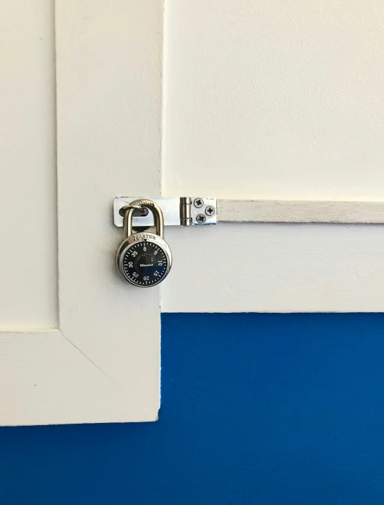 the clock is on top of the metal door handle