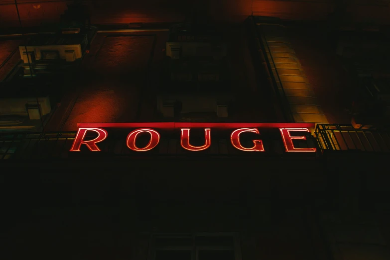 the roughge sign in red lit up at night