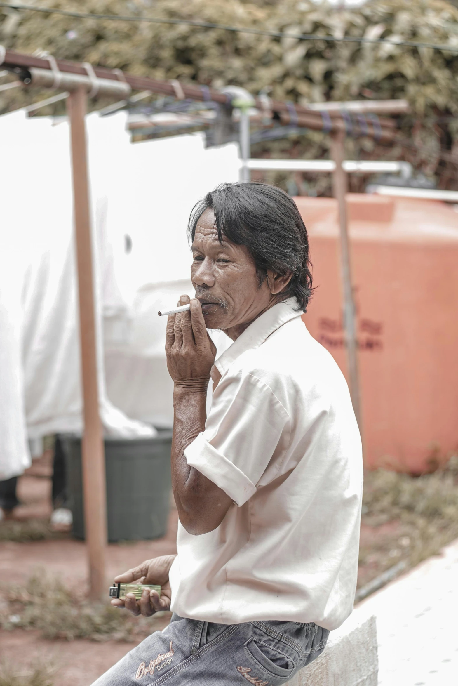 a person is smoking on the street corner