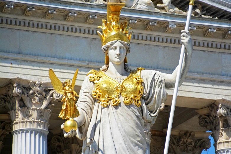 the statue of lady liberty holds a golden crown and a staff