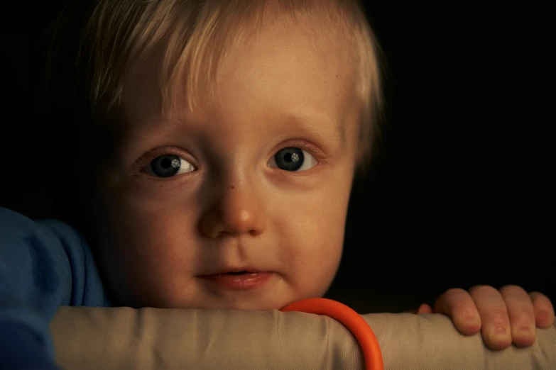 an infant looking at the camera with a blurry background