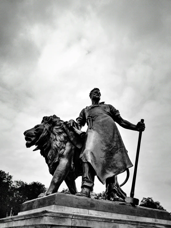 a statue of a man with a staff and shield