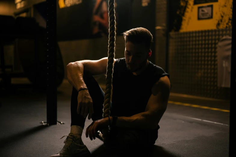 a man tying his shoes and looking down