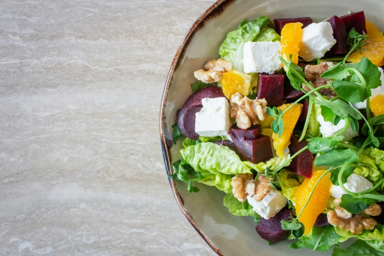 a plate topped with salad on top of a table