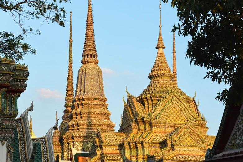 the top of an old building with steeples against a blue sky