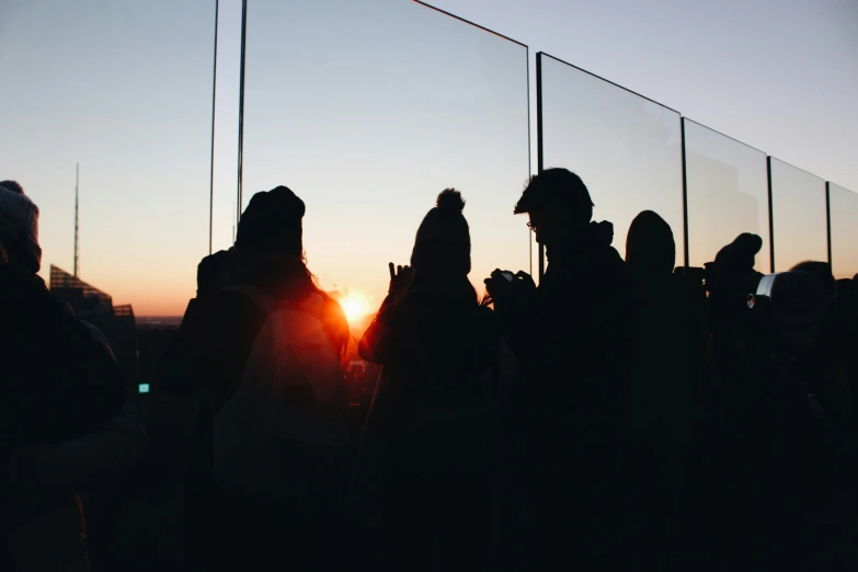 several people at a party and a couple of people with a cell phone