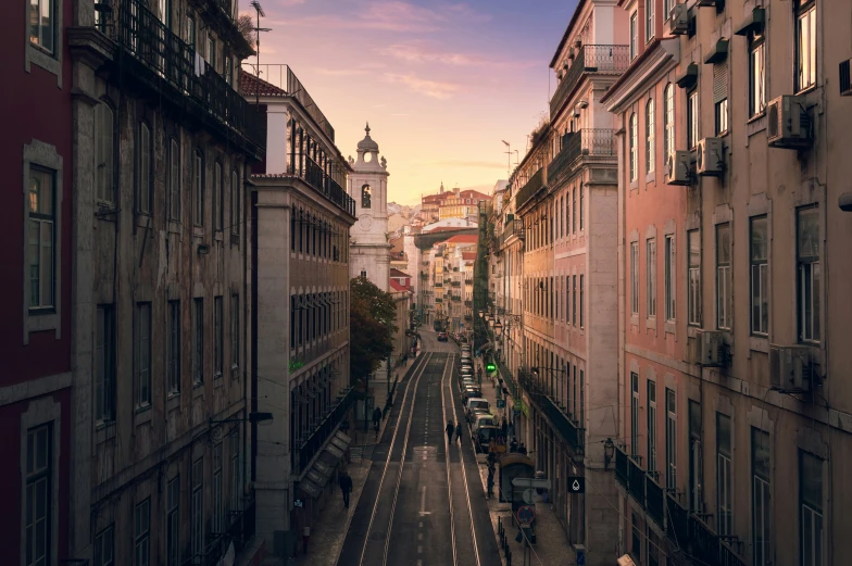 a street with buildings and cars on both sides