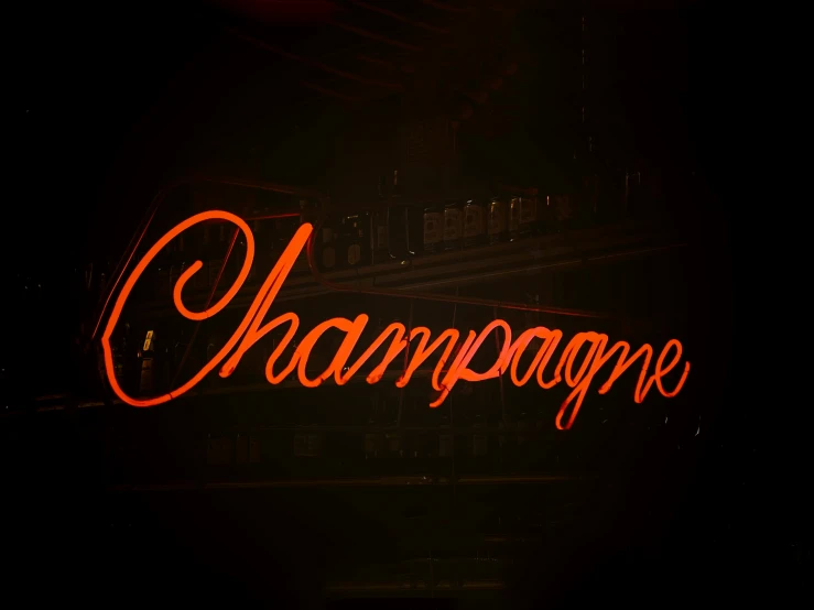 the word champagne on display in the dark