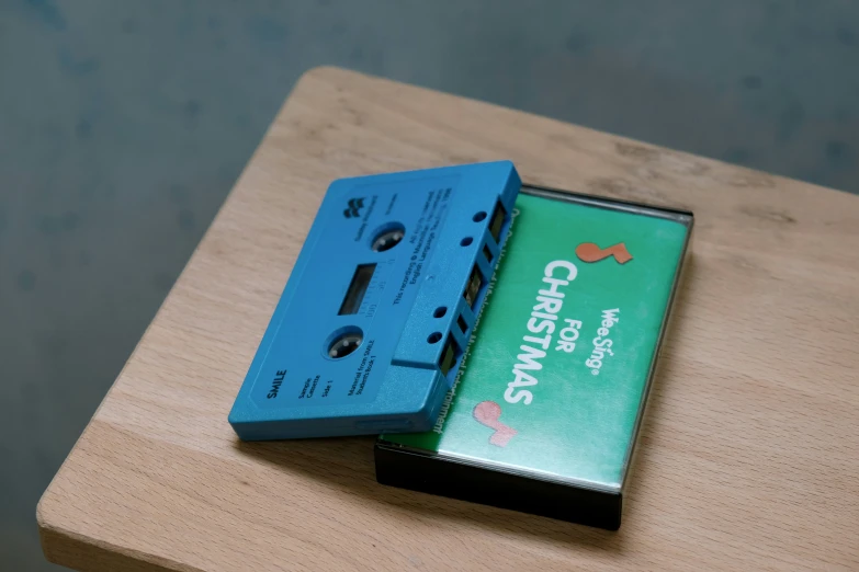 a single cassette and audio player on top of a wood table