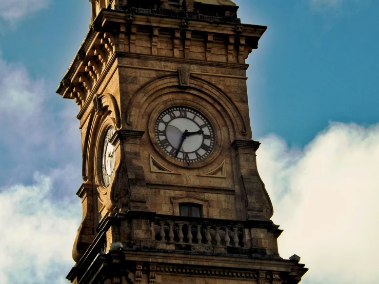 a tall clock tower sitting under a blue sky