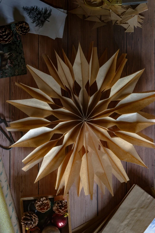 large wooden flower sitting on top of a wooden floor