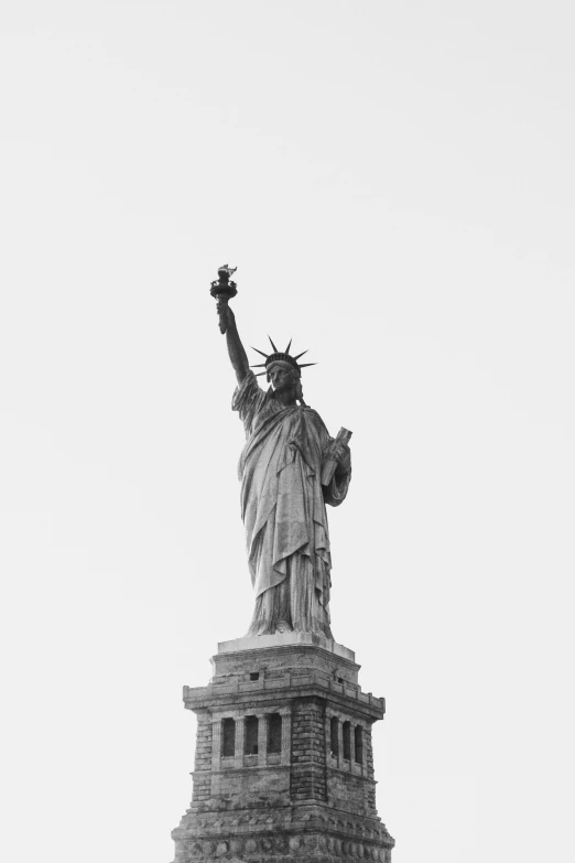 a statue of liberty against a cloudy sky