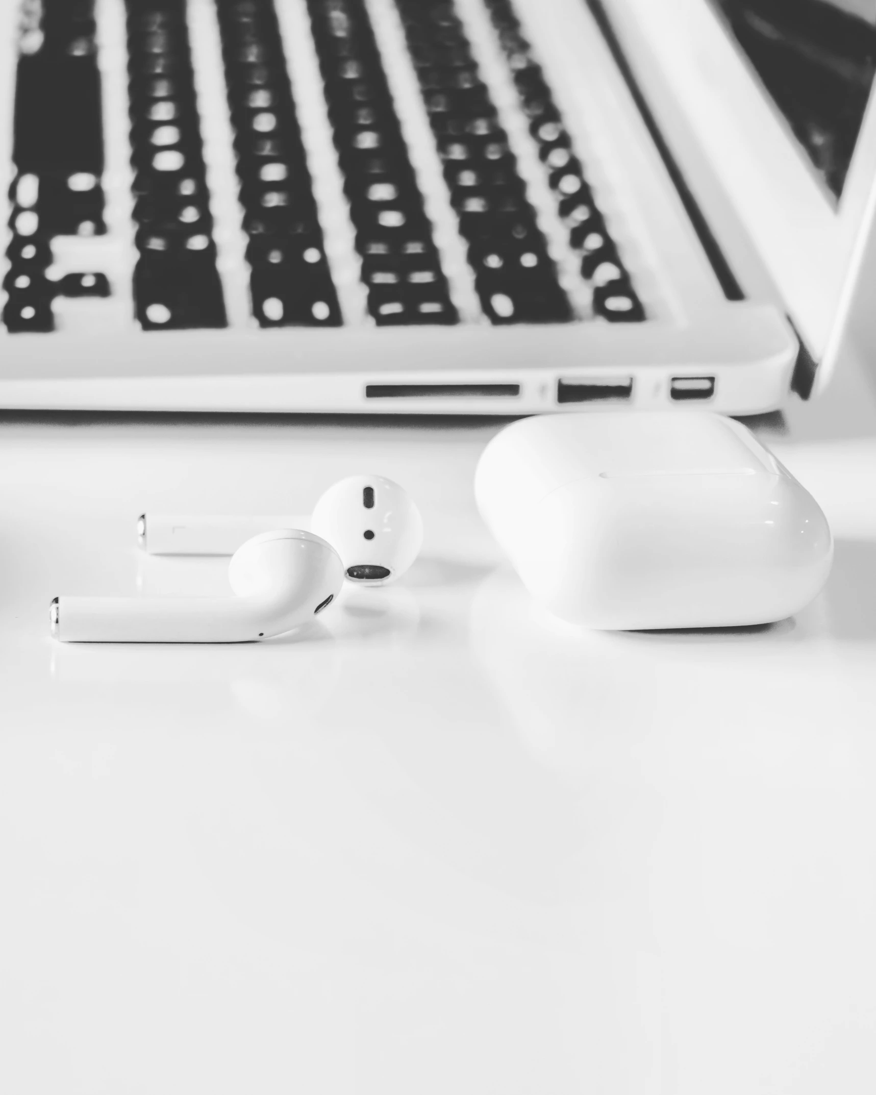 there are two headsets and a laptop sitting on the table