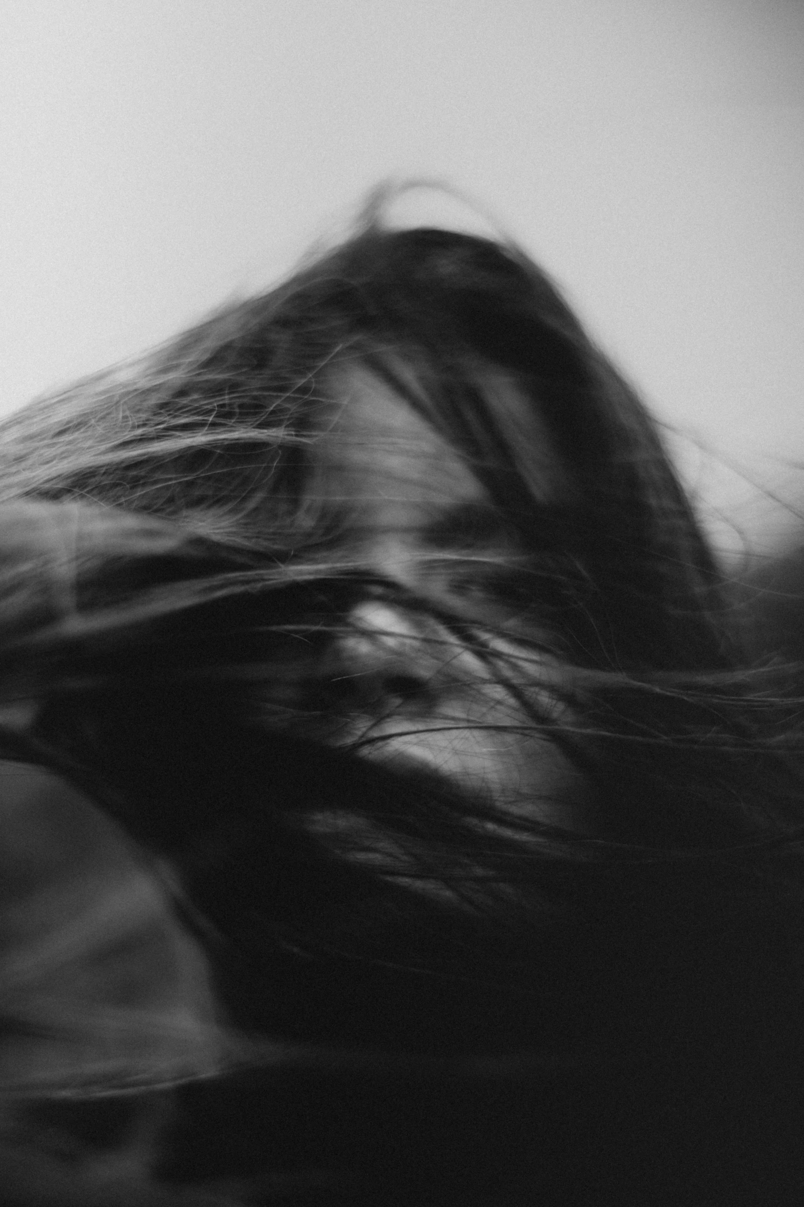 black and white pograph of a blurry woman's head