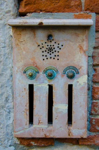an old, dirty electrical box with decorative design on the wall