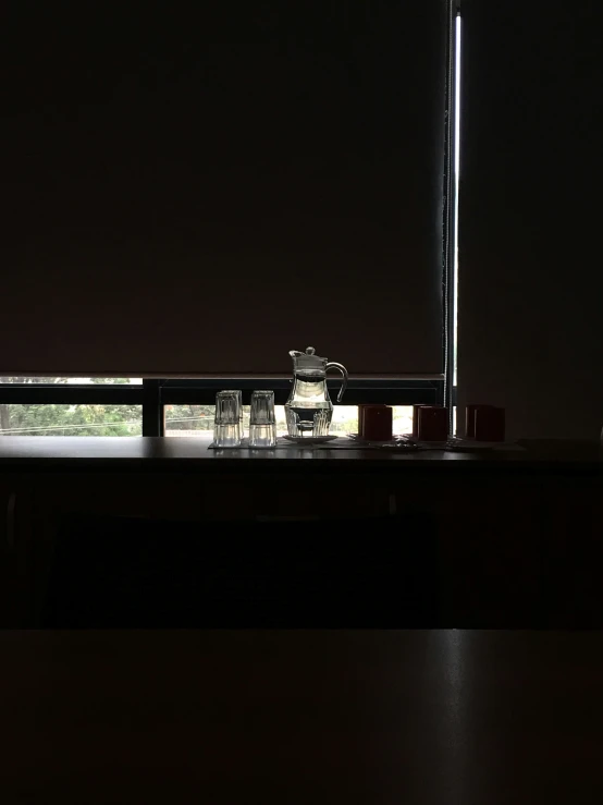 bottles sitting on top of a dark desk