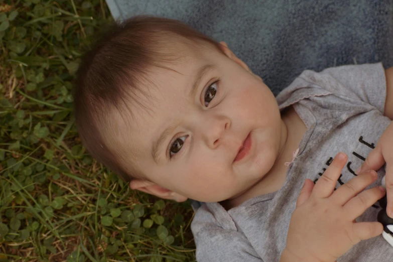 a child holding onto a baby mobile phone