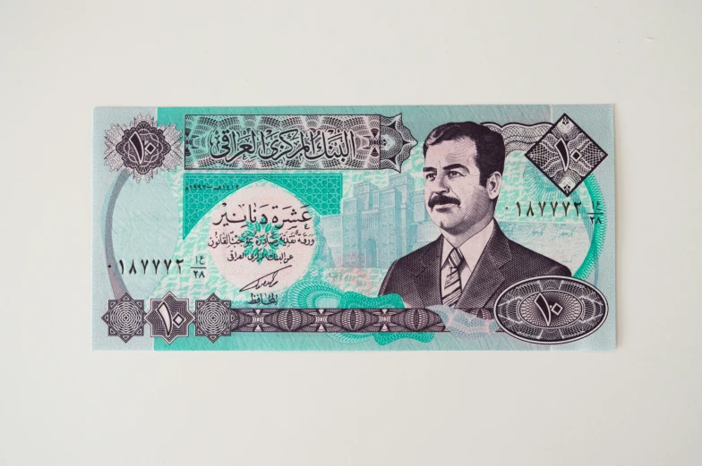 a picture of the portrait of a man with a beard in arabic writing on an indian currency bill