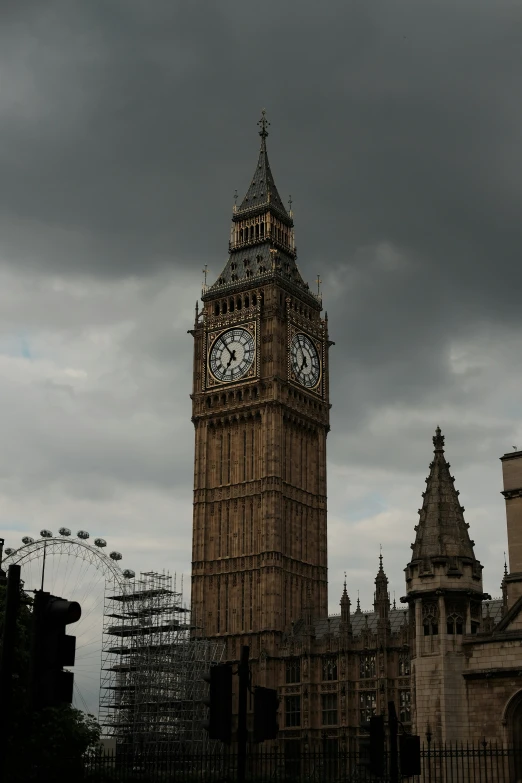 an old building with a clock and the top of it in a city