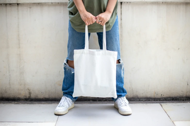 the back legs of someone holding a shopping bag