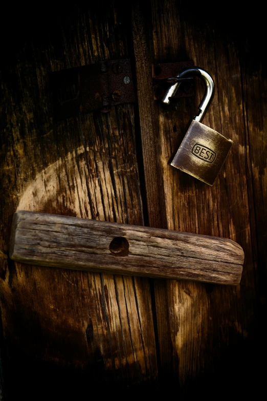 a close up of a padlock on a wooden door